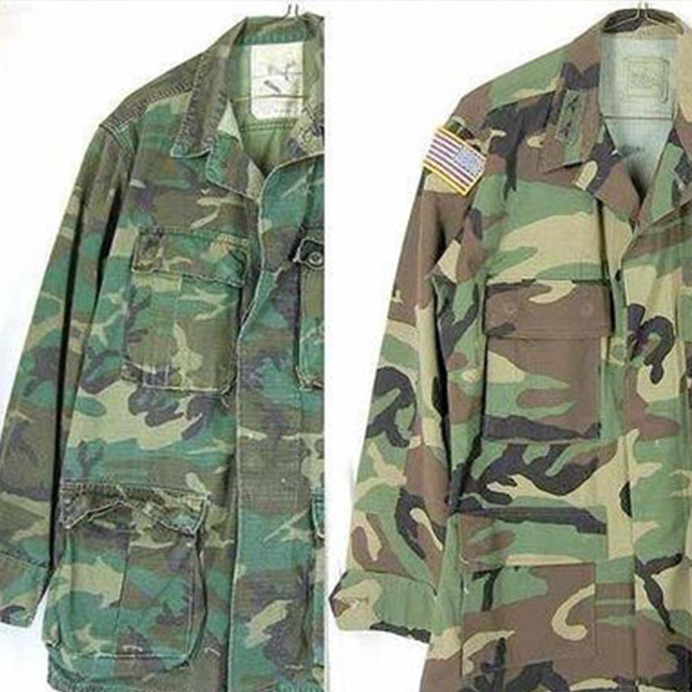 Two camouflage military jackets, one with faded colors and one with a U.S. flag patch on the shoulder.