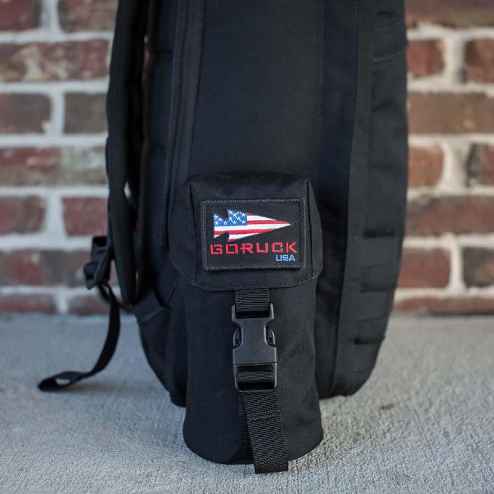 GORUCK's Full Panel Water Bottle Pocket, a black backpack featuring an American flag patch and the