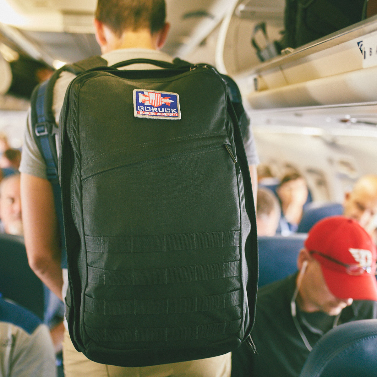 GORUCK backpack worn by passenger on airplane, durable rucking gear for travel