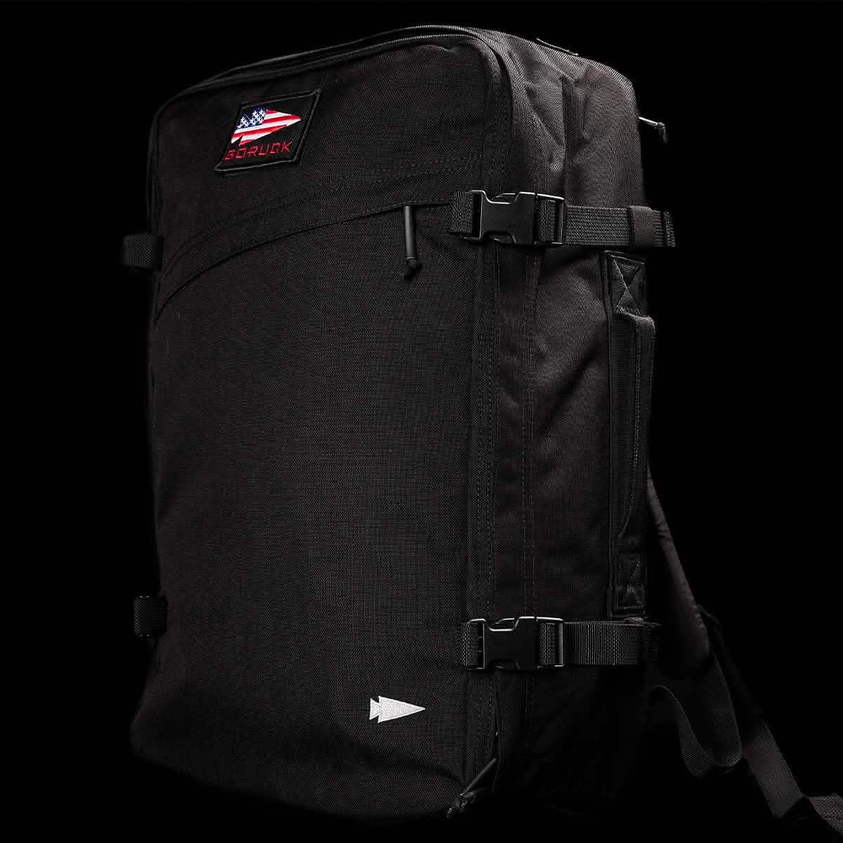 The GORUCK GR3 - Cordura is a black carry-on rucksack with buckle straps, waterproof zippers, and an American flag patch, shown against a black background.