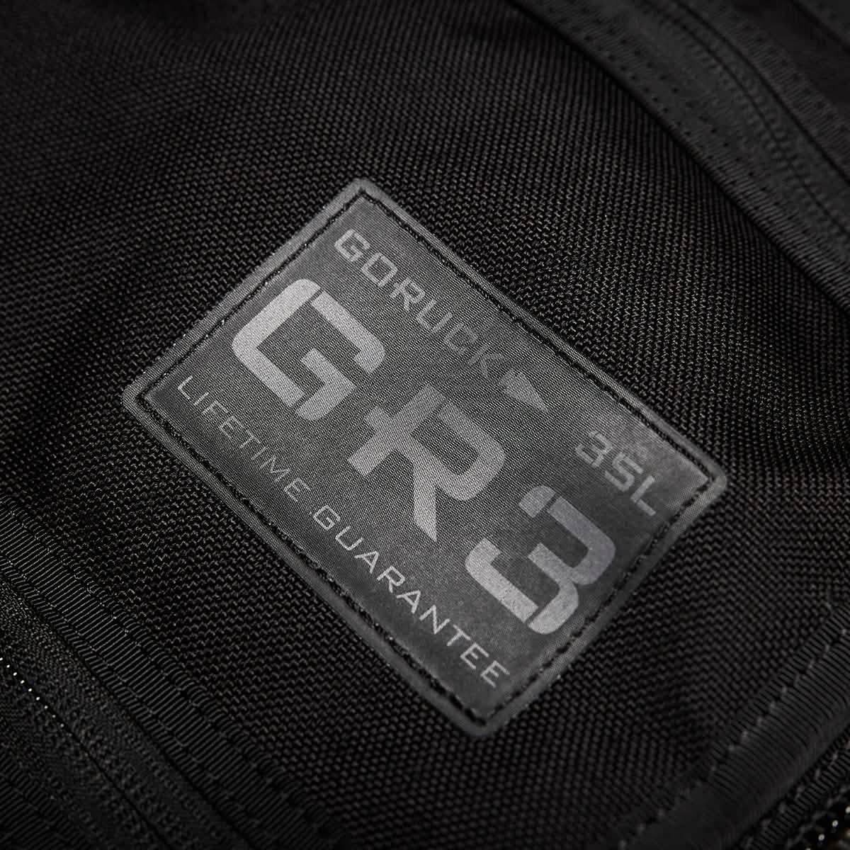 Close-up of a black GORUCK GR3 - Cordura backpack label highlighting its rugged design, waterproof zippers, and