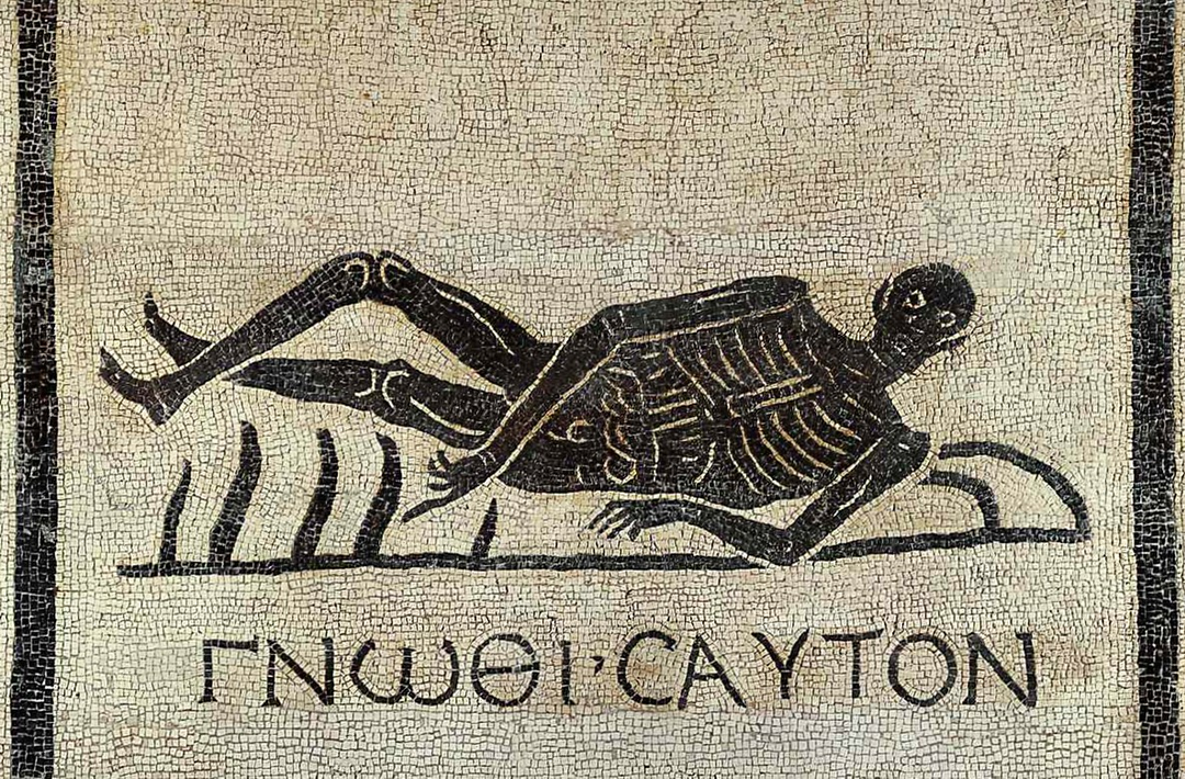 Ancient mosaic art of a reclining skeleton with Greek text, on a stone tile background