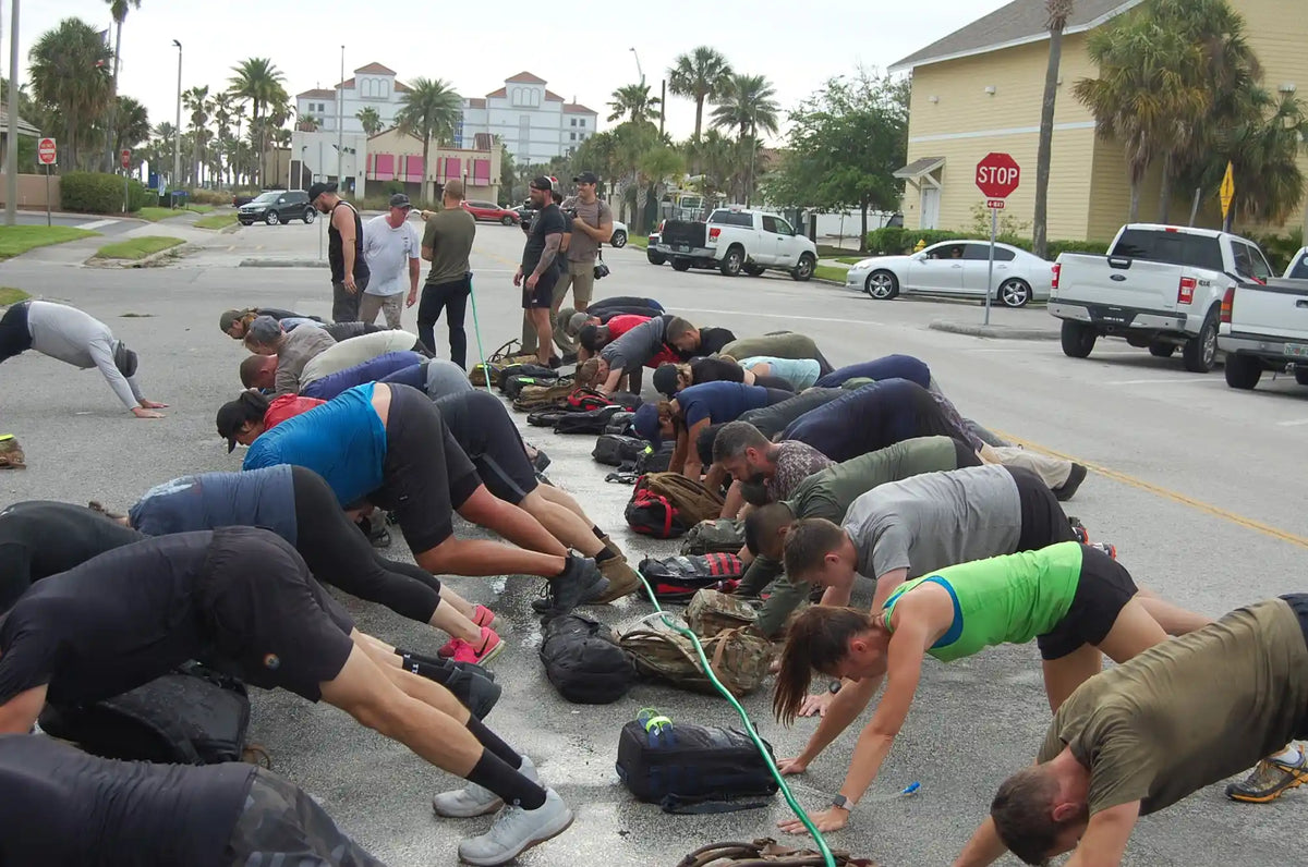 GORUCK group doing outdoor rucking workout with backpacks in an urban street setting