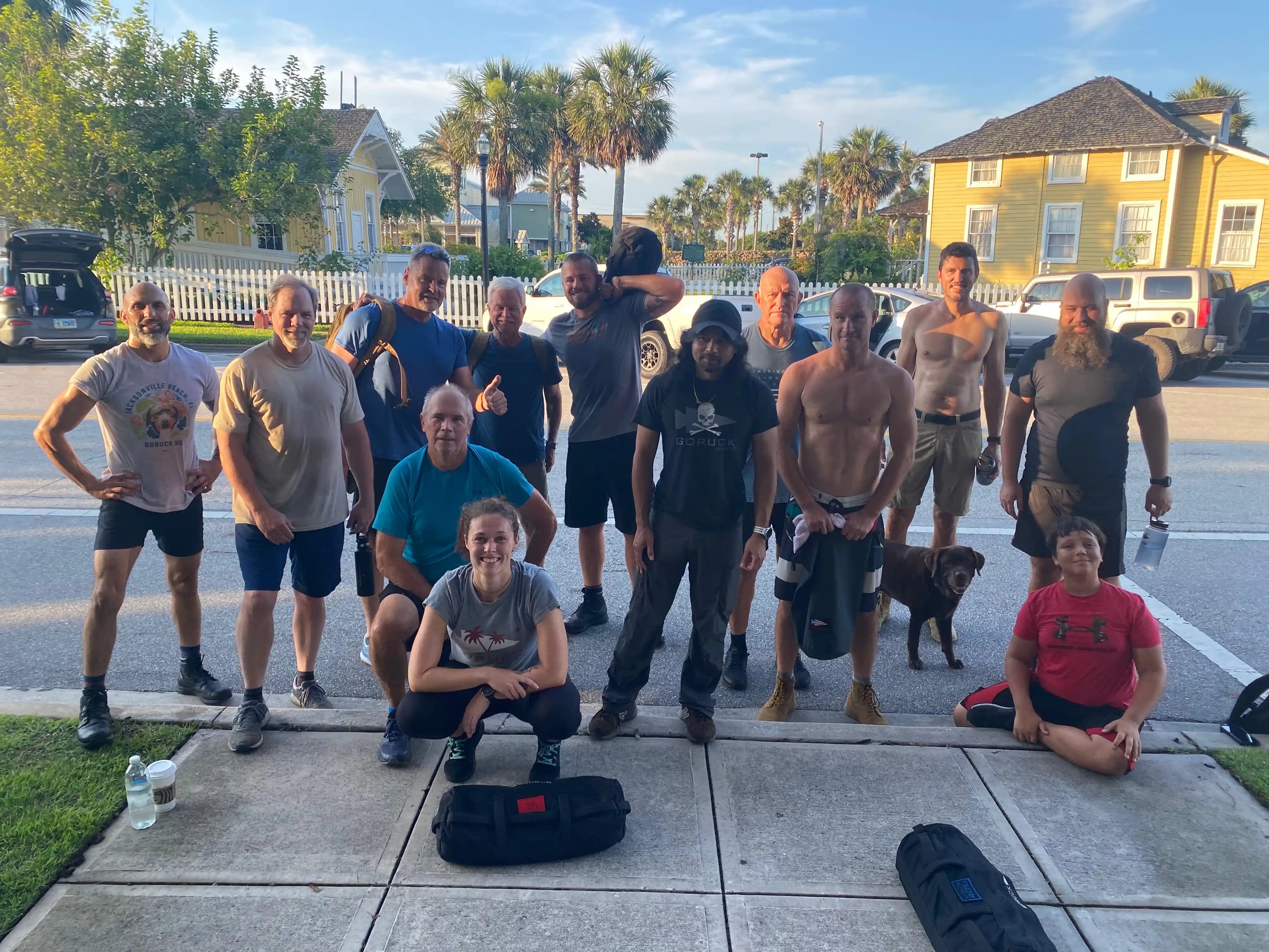 GORUCK rucking group outdoors with fitness gear, smiling after group workout on sidewalk
