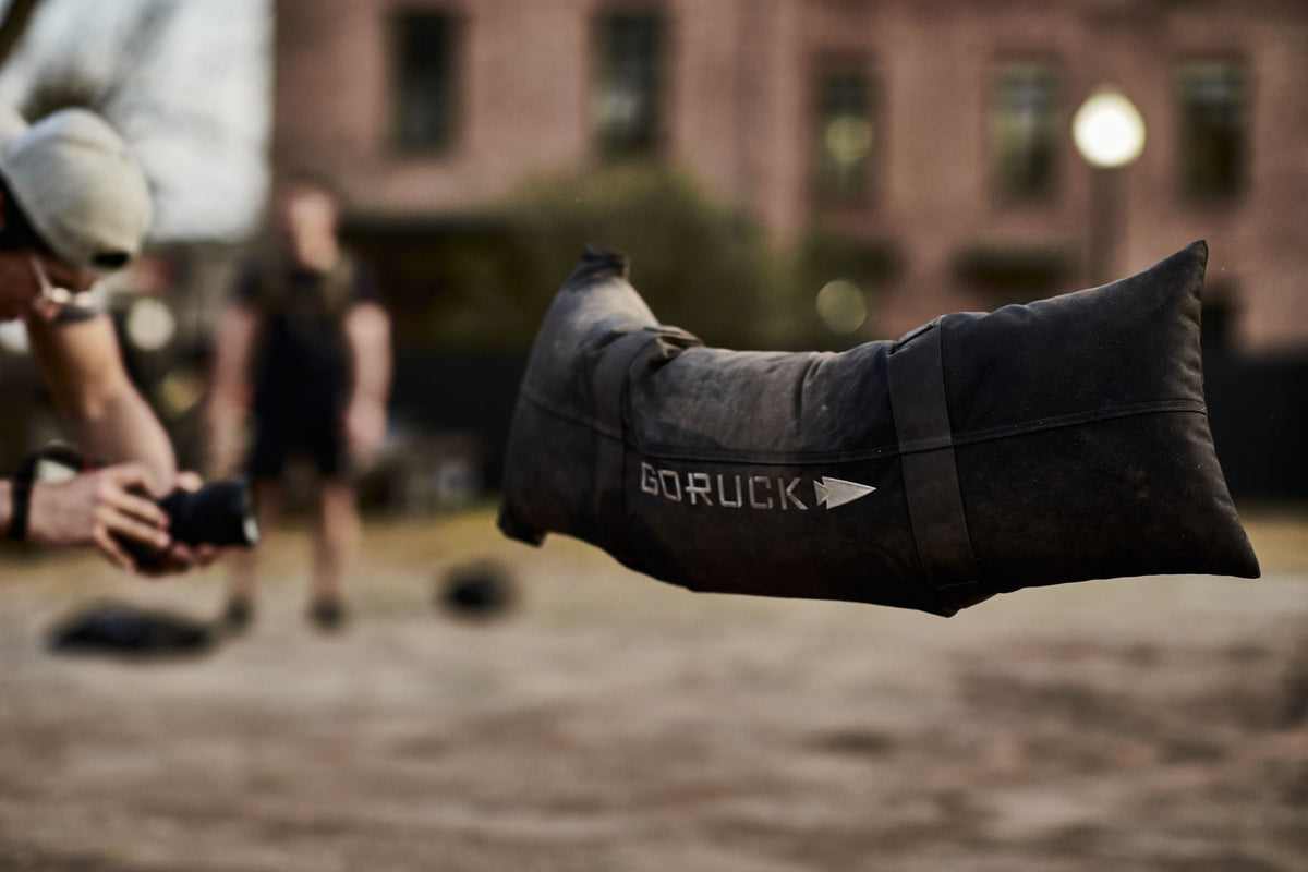 GORUCK sandbag in outdoor workout setting, focus on rugged rucking gear in action