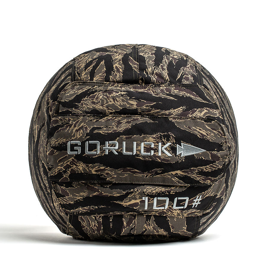 The Sand Medicine Ball by GORUCK is designed with a camouflage pattern and 
