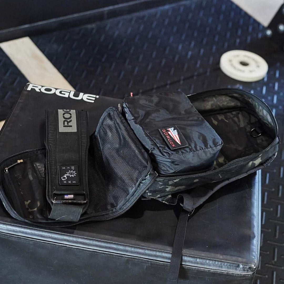 A set of GORUCK Packing Cubes made from durable 200D Nylon, resting on a padded gym bench near equipment.