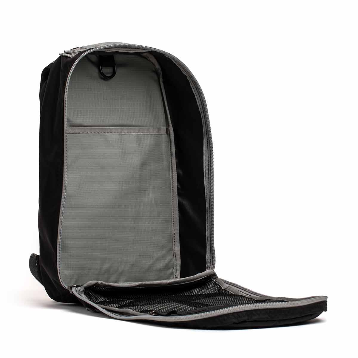 A black backpack with its main compartment fully unzipped, showing a spacious gray interior and mesh pocket.