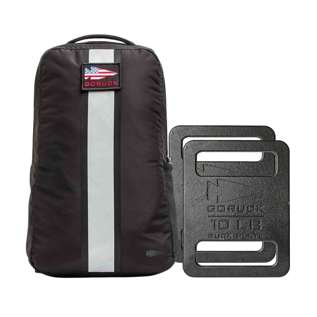 The Basic Rucker Bundle features a black GORUCK backpack with a USA flag patch and two black 10 lb ruck plates, ideal for rucking or weighted workouts.