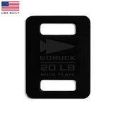 The GORUCK Ruck Plates - LB, colored in black and weighing 20 lb, are ideal for your Rucker workouts and come adorned with an arrow logo and a "USA Built" flag in the corner.