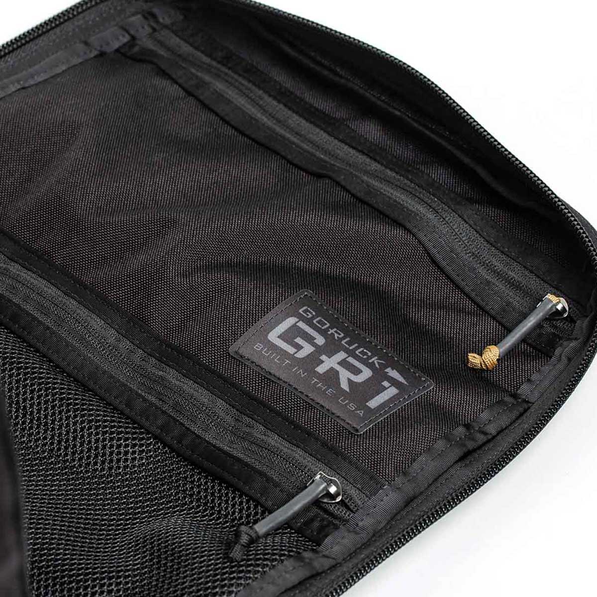 Open black rucksack with zipper pockets, featuring a 