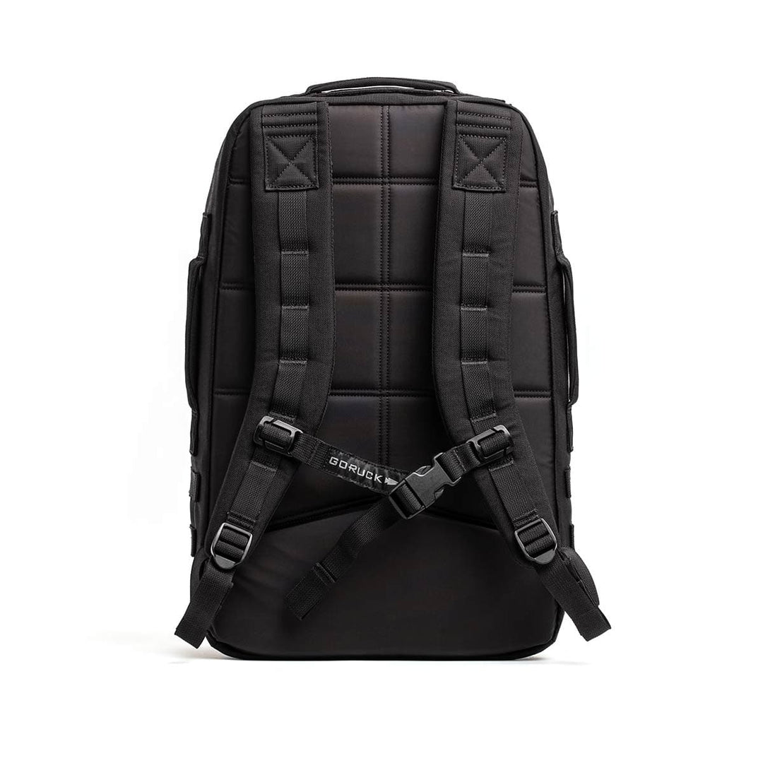 The GORUCK Rucker 4.0 backpack in black comes with padded straps and a sternum strap, featuring a quilted back panel for comfort during rucking. The bottom strap displays a center logo, highlighting a design centered on durability and utility.