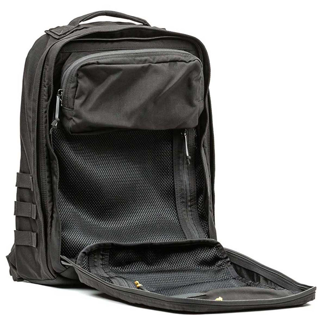 The GR2 backpack by GORUCK, available in black, features multiple compartments and an unzipped front pocket that exposes its interior mesh lining. Built to withstand harsh conditions, it is backed by the Scars Lifetime Guarantee to ensure peace of mind during any adventure.
