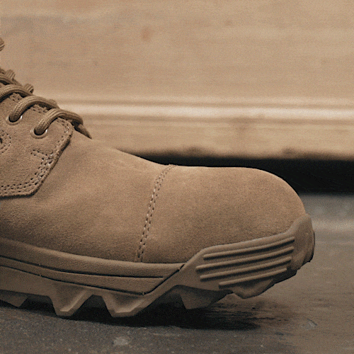 A tan work boot stomps on a nail, which bends under the sole without piercing the boot.