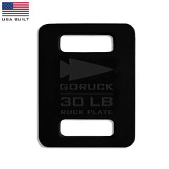 The GORUCK Ruck Plates - 30 lb, in black, offer convenient cutout handles and are designed to fit perfectly in your Rucker or any Ruck Plate Carrier. They feature a sleek American flag in the corner, symbolizing quality and endurance for your toughest challenges.