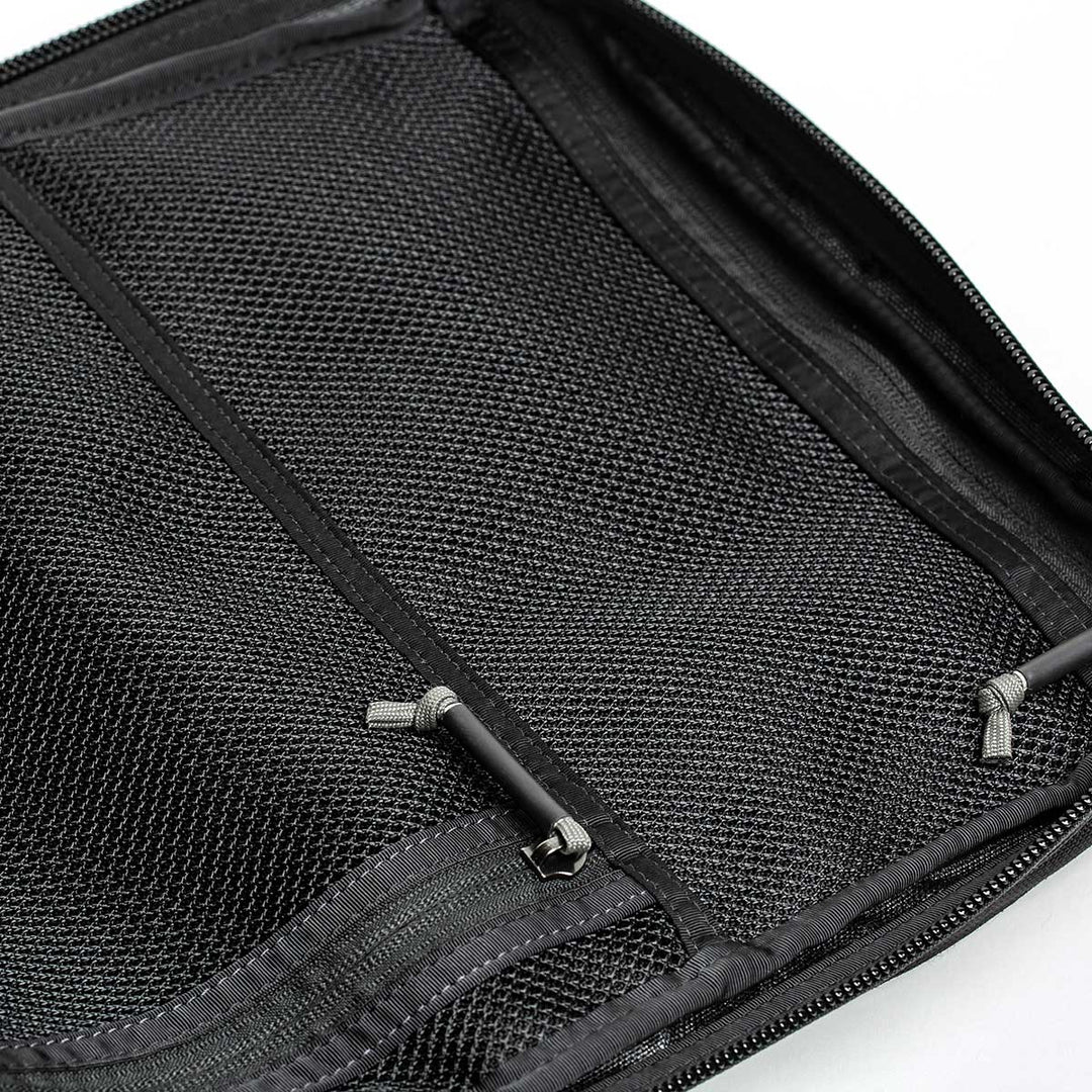 Close-up of an open mesh organizer pocket with zippers and elastic straps in the GR2 by GORUCK, perfect for a rucksack.