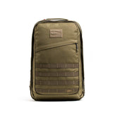 The GORUCK GR2 olive green tactical carry-on rucksack features a front zipper pocket and MOLLE webbing, shown standing upright against a white background.