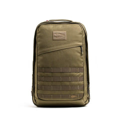 The GORUCK GR2 olive green tactical carry-on rucksack features a front zipper pocket and MOLLE webbing, shown standing upright against a white background.