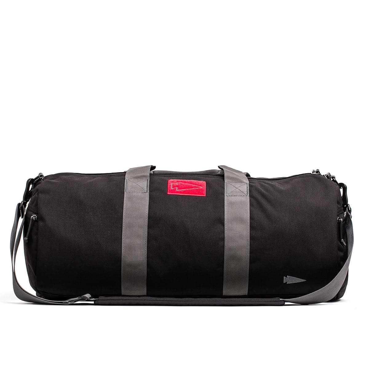 Introducing the GORUCK Gym Bag - Cordura, a sleek 38L bag crafted from durable CORDURA fabric, featuring gray straps and a distinct red label on the side.