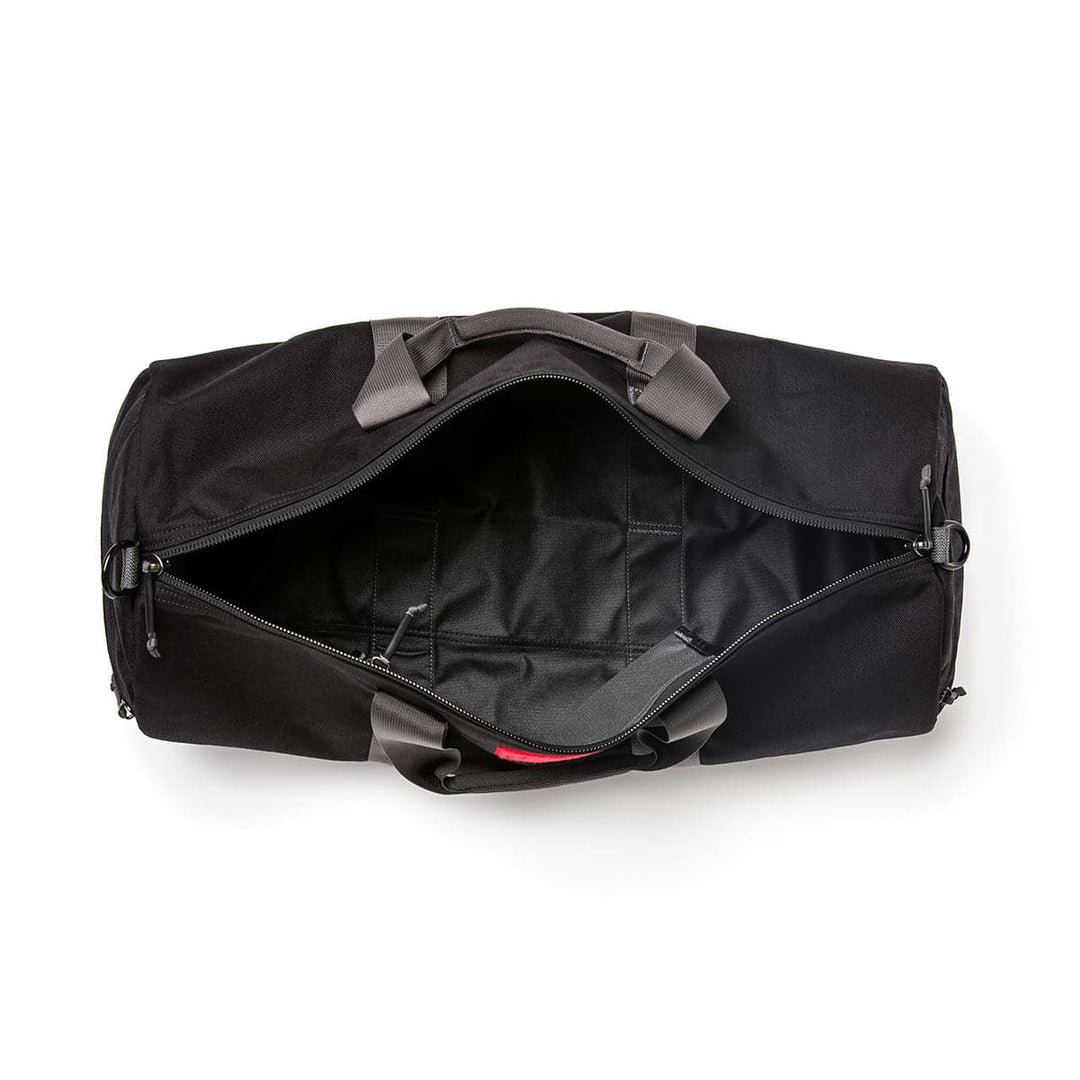 The Gym Bag - Cordura by GORUCK, featuring a 38-liter capacity in black with gray handles and an open zipper, is crafted from durable CORDURA material and viewed from above.