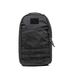 The Bullet Ruck - Classic -15L is a sleek black tactical backpack featuring a front zipper pocket and horizontal webbing, ideal as a 15L daypack for carrying daily essentials.