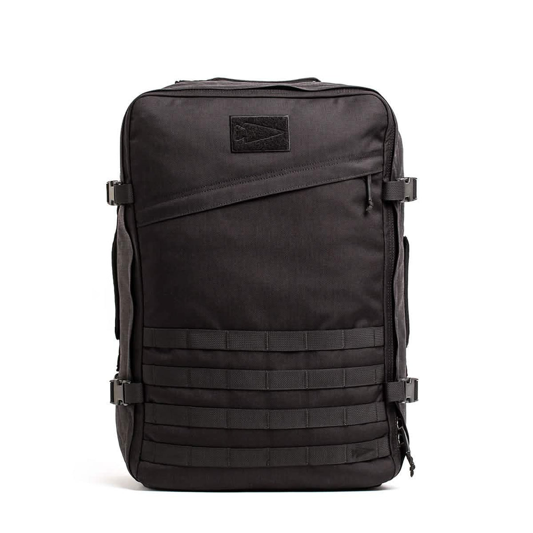 The GORUCK GR3 – Cordura backpack in black features multiple straps, buckles, and a zippered front pocket—ideal as a carry-on rucksack for adventure travel, shown on a white background.