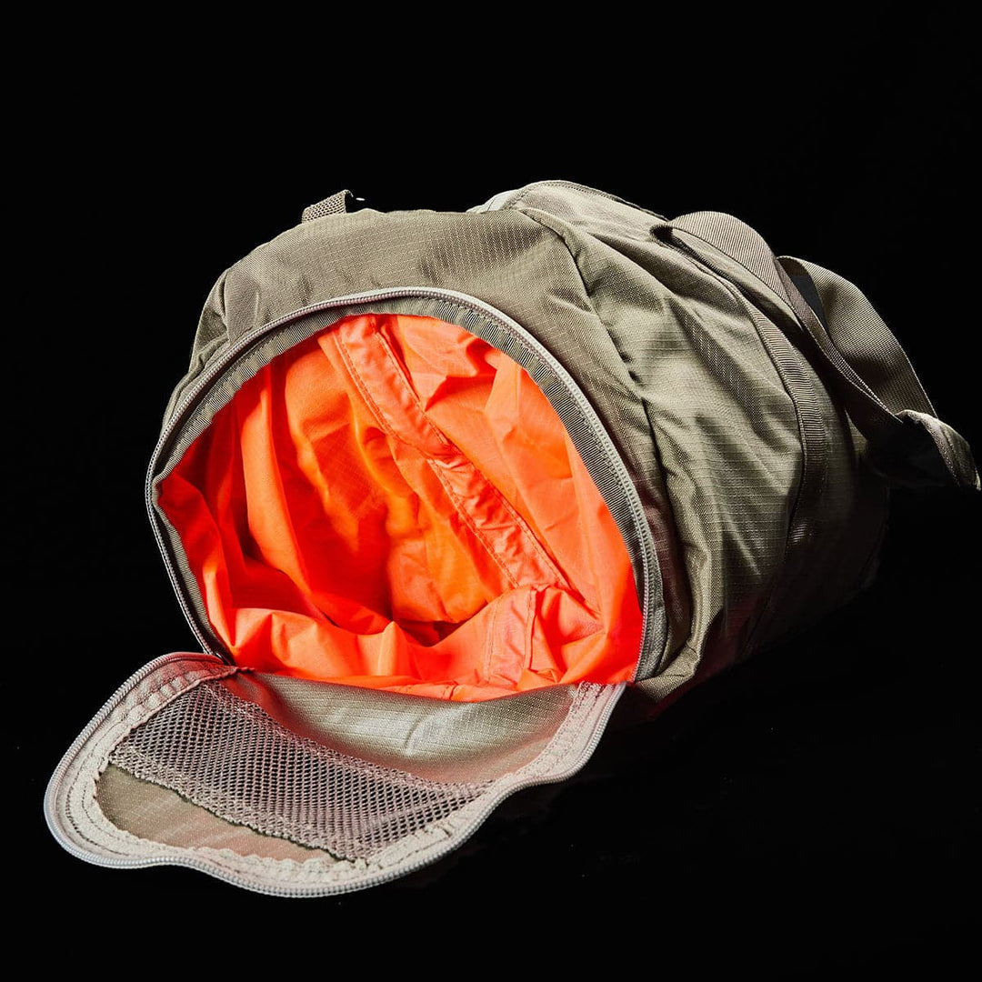 The GORUCK Gym Bag - Ripstop ROBIC® is a sturdy gym bag made from durable ripstop nylon, with a bright orange open interior, a partially unzipped mesh pocket, and a convenient shoe compartment.