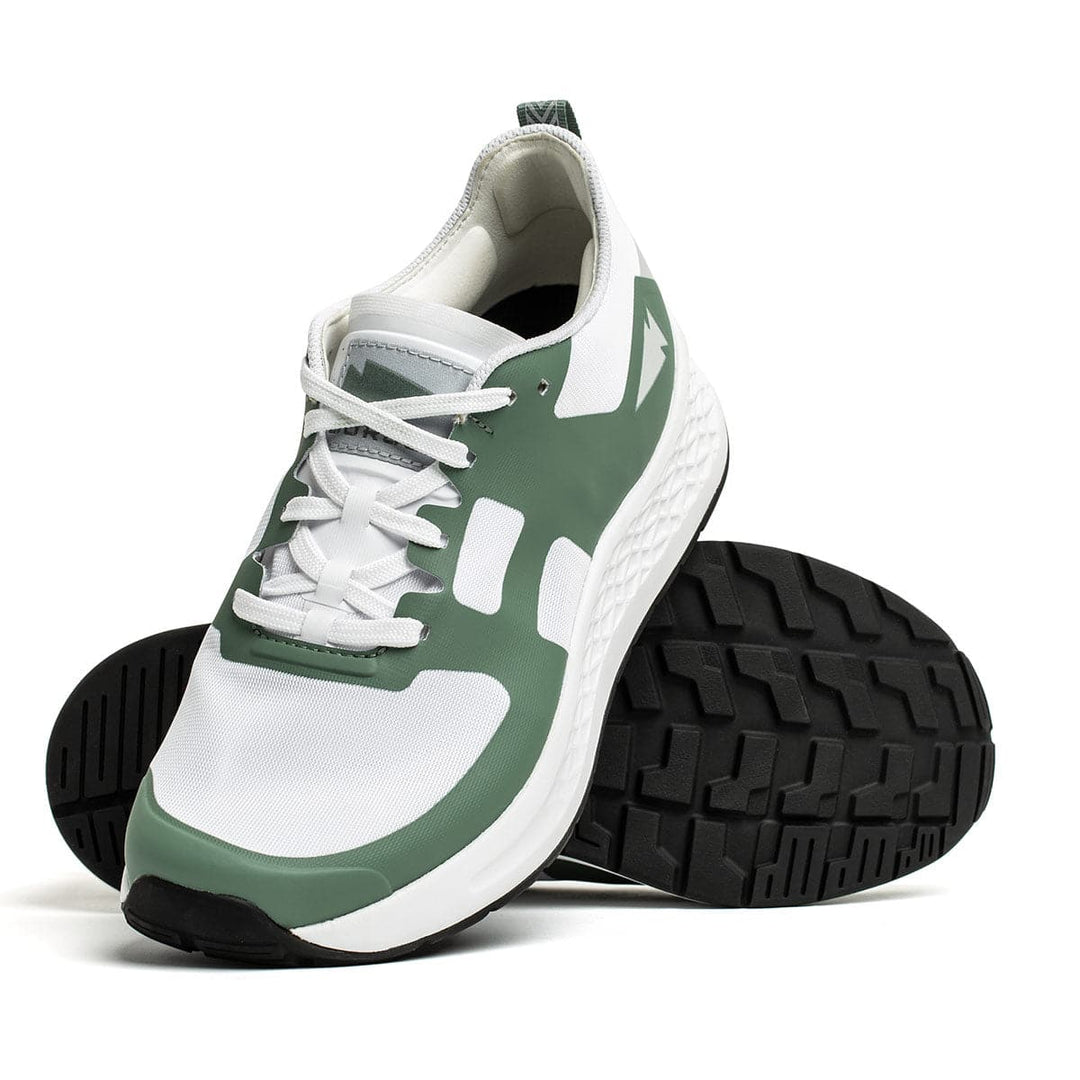 A pair of Men's Rough Runner - Seaspray athletic shoes from GORUCK features white and green uppers with black textured soles made from Gradient Density EVA. One shoe stands upright while the other leans against it, showcasing the design and tread pattern.