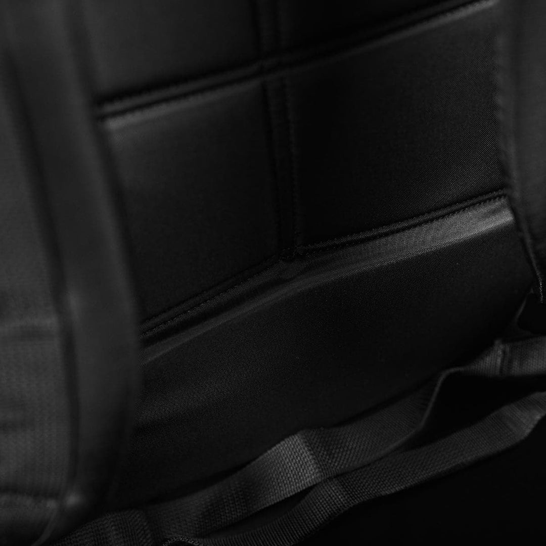 Close-up of the GORUCK Bullet Ruck Double Compartment's padded interior, showcasing its intricate stitching and dual compartments crafted from durable ripstop nylon with sturdy straps.
