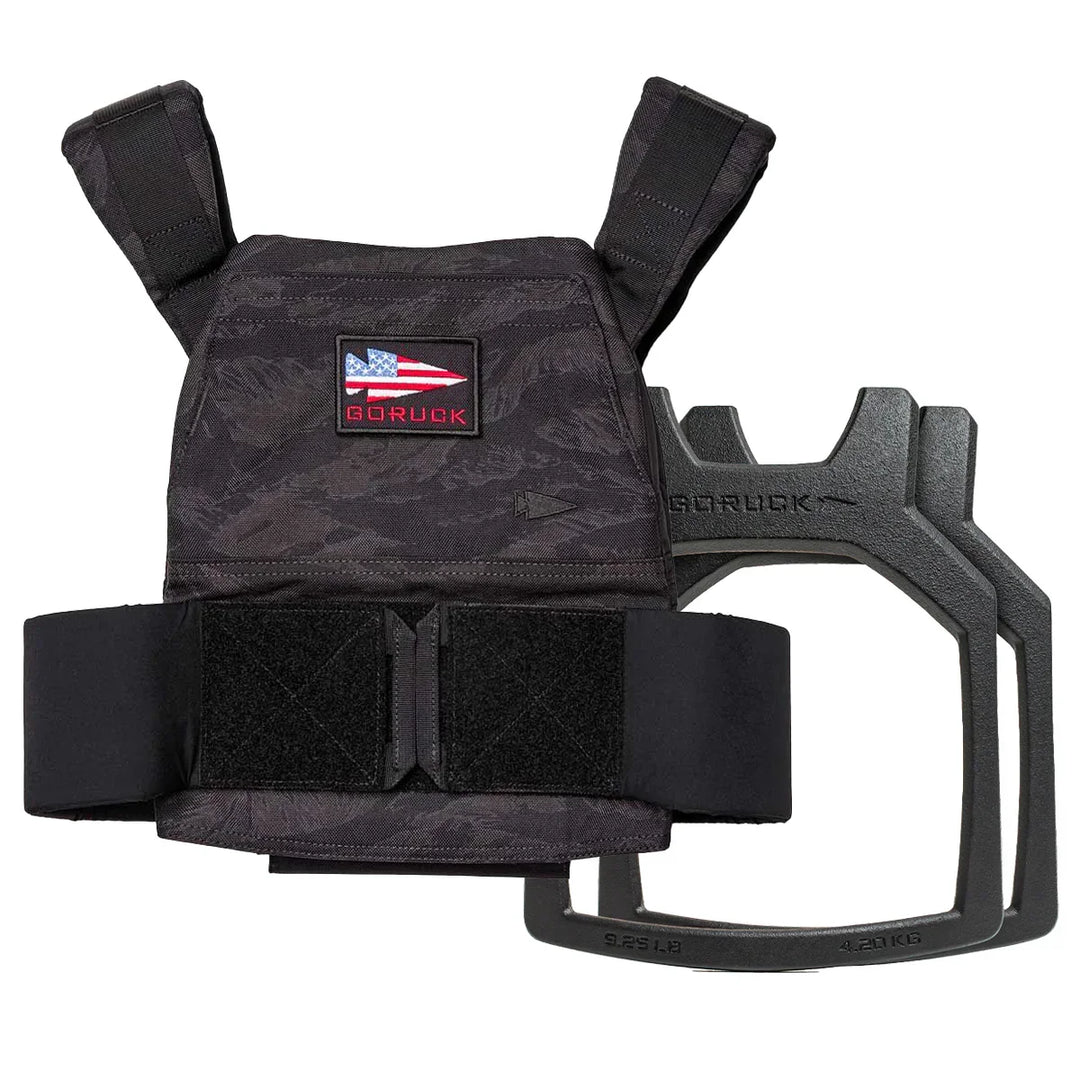 The Rucking Weight Vest + Curved Plate Bundle, featuring a black vest with an American flag patch and a removable curved ruck plate, is perfect for building your rucking bundle.
