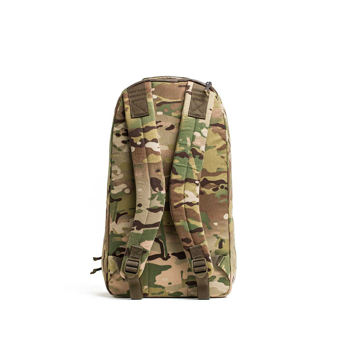 The GORUCK Bullet X-PAC is a weatherproof backpack with a simple design, featuring two padded shoulder straps. Shown from the back in camouflage, it’s ideal for everyday use.
