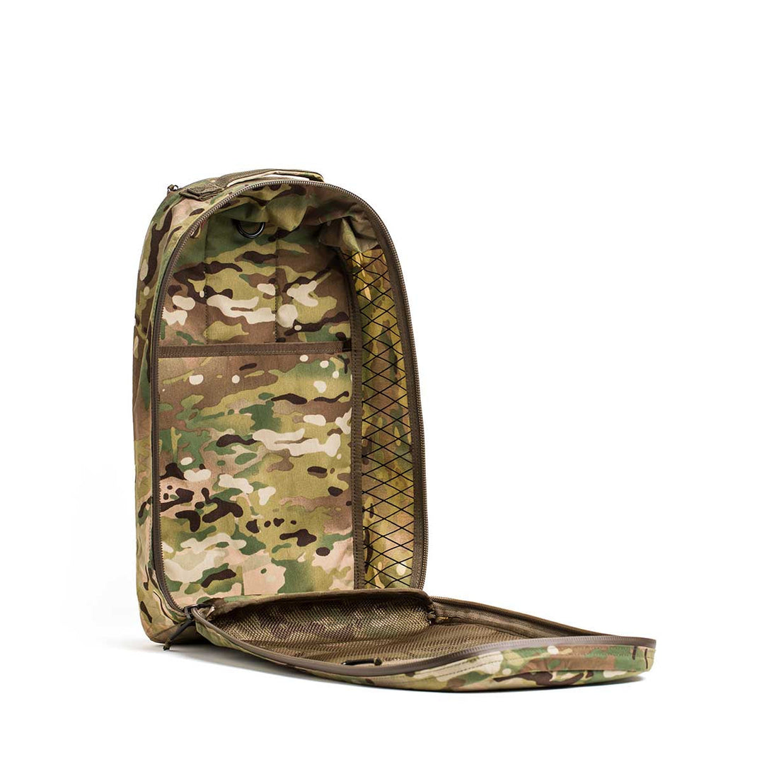 The GORUCK Bullet X-PAC, a weatherproof backpack in camouflage, features a zippered lid and elastic mesh pocket, made from durable X-PAC material. Shown against a white background.