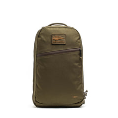 The Double Compartment Bullet Ruck - Ballistic Nylon Cordura - 18L by GORUCK EU is an olive green carry-on backpack featuring a top handle, a front zipper pocket, and a rectangular logo patch near the top. It includes a bombproof laptop compartment to keep your devices secure on the go.