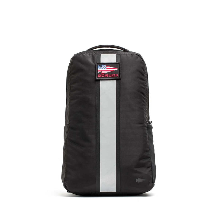 The Basic Rucker® is a black rucking backpack with a vertical reflective stripe and an American flag GORUCK patch, perfect as a weighted rucksack for your toughest challenges.