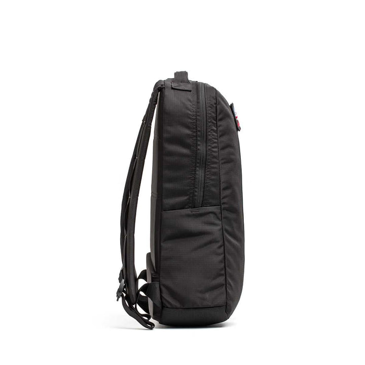 Side view of the black Basic Rucker® with a slim profile, visible zipper, and adjustable shoulder straps—perfect as a rucking backpack for fitness enthusiasts.