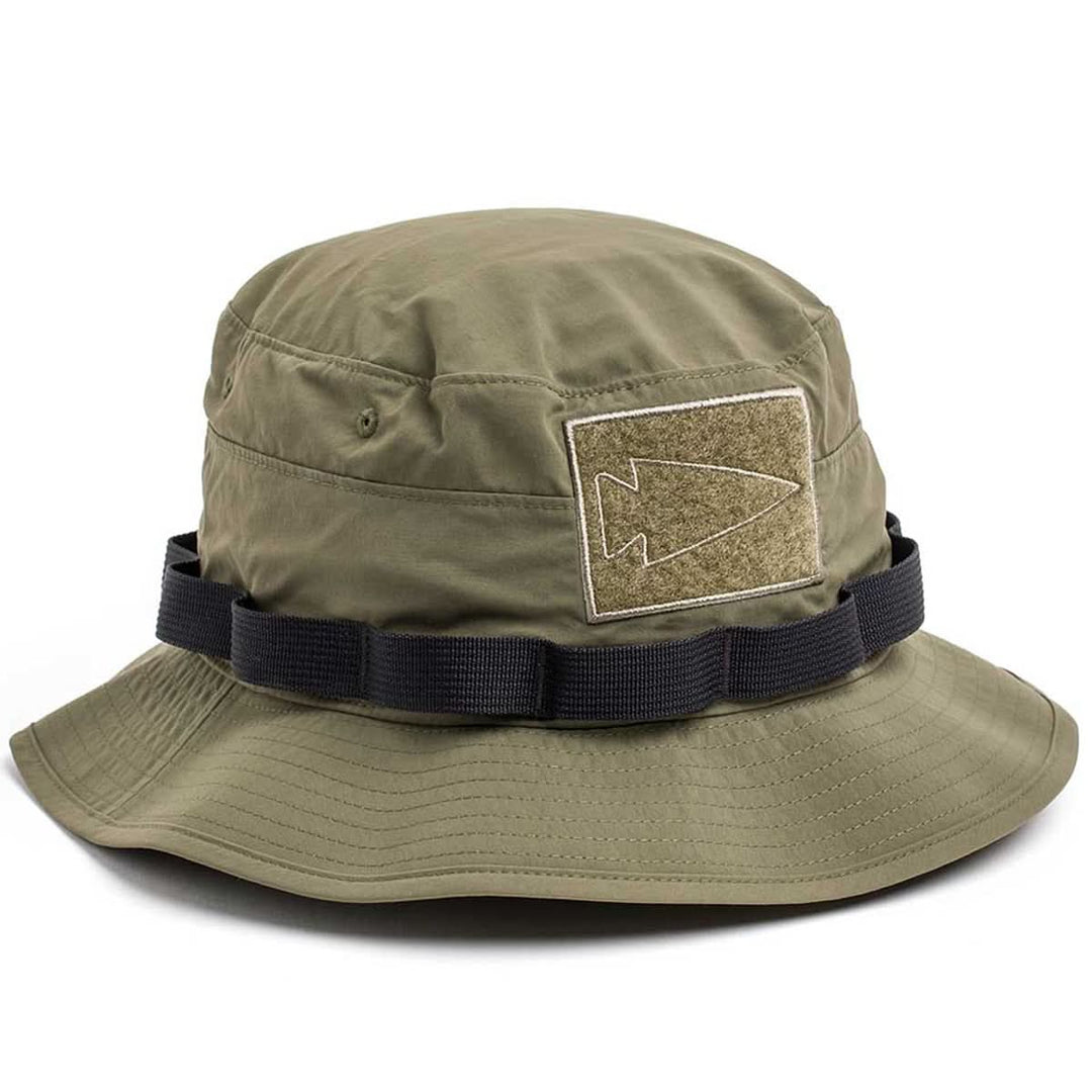 The GORUCK Boonie Hat - Tactical - ToughDry in olive green features a black strap, arrowhead patch, and 50+ UPF sun protection.