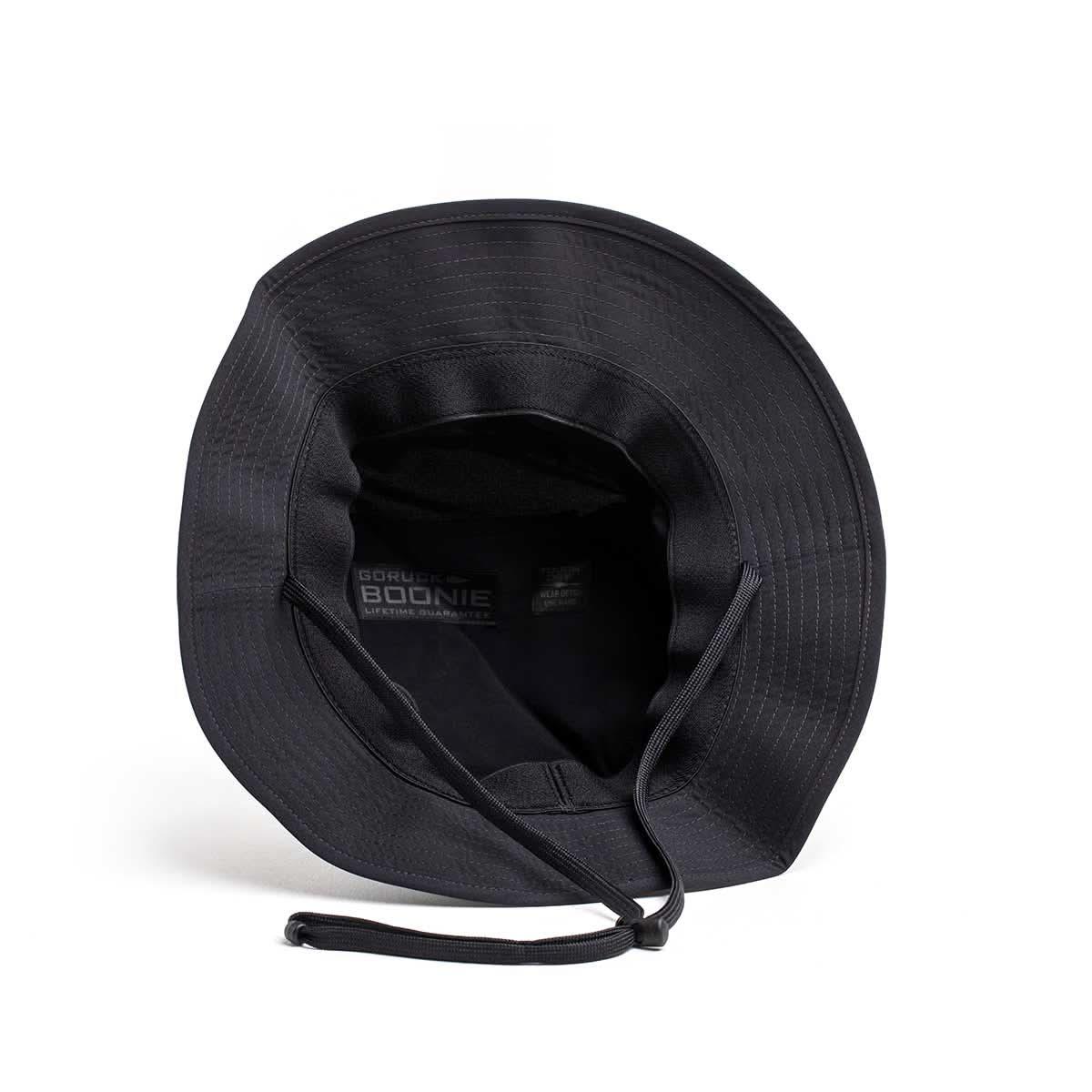 Black GORUCK Boonie Hat with chin strap, tough rucking gear, top view on white background.