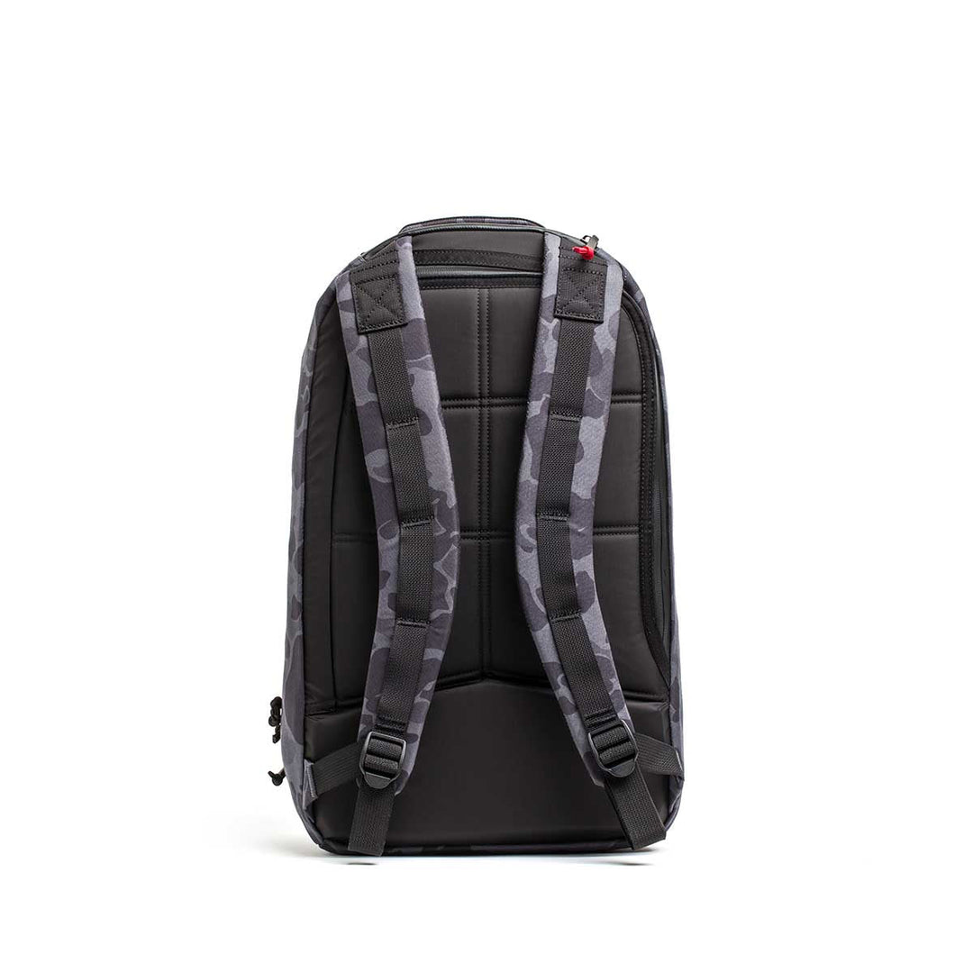 The Double Compartment Bullet Ruck - Ballistic Nylon Cordura - 18L is shown from the back in gray camo, featuring padded straps, a quilted back panel, and a bombproof laptop compartment.