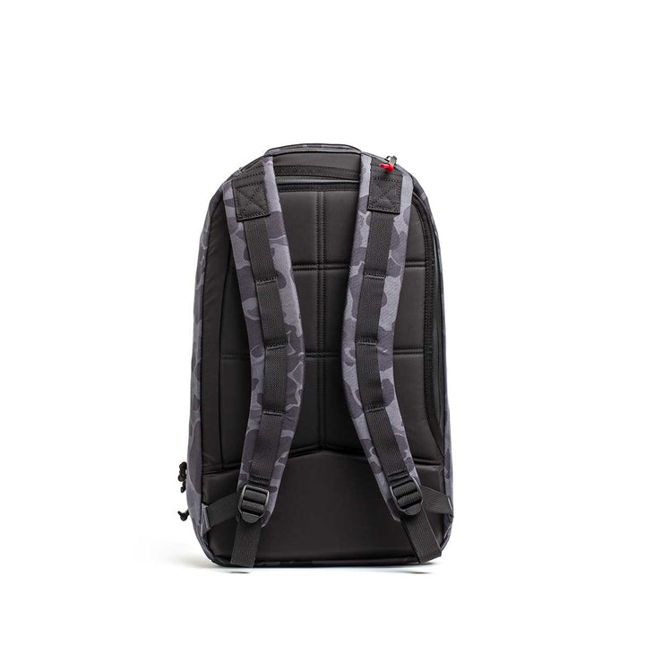 The Double Compartment Bullet Ruck - Ballistic Nylon Cordura - 18L is shown from the back in gray camo, featuring padded straps, a quilted back panel, and a bombproof laptop compartment.