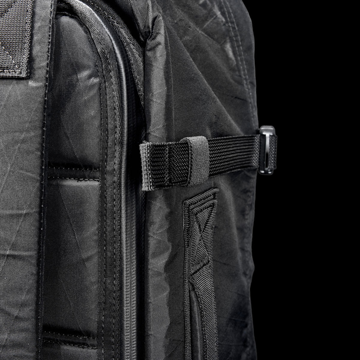 GORUCK black rucksack close-up, durable X-Pac material, compression strap detail