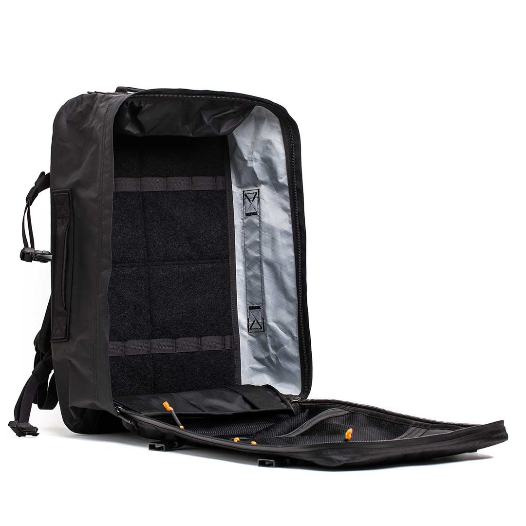 The GORUCK GR3 - X-PAC backpack stands upright with its main compartment fully unzipped, showing its spacious waterproof interior—perfect as carry-on luggage.