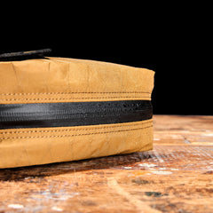 GORUCK coyote brown XPac bag detail with water-resistant zipper on wooden surface
