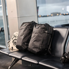 GORUCK black rucksacks on airport bench, rugged travel backpacks ready for rucking adventure