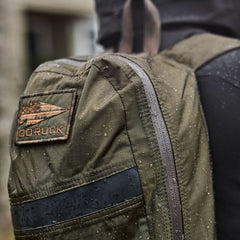 GORUCK waterproof backpack with logo patch and rain droplets outdoors