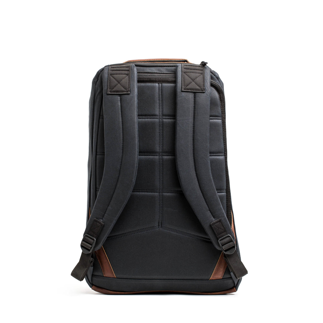 Back view of the GORUCK GR1 USA - Heritage rucksack in waxed duck canvas, featuring padded straps and brown accents on a white background.