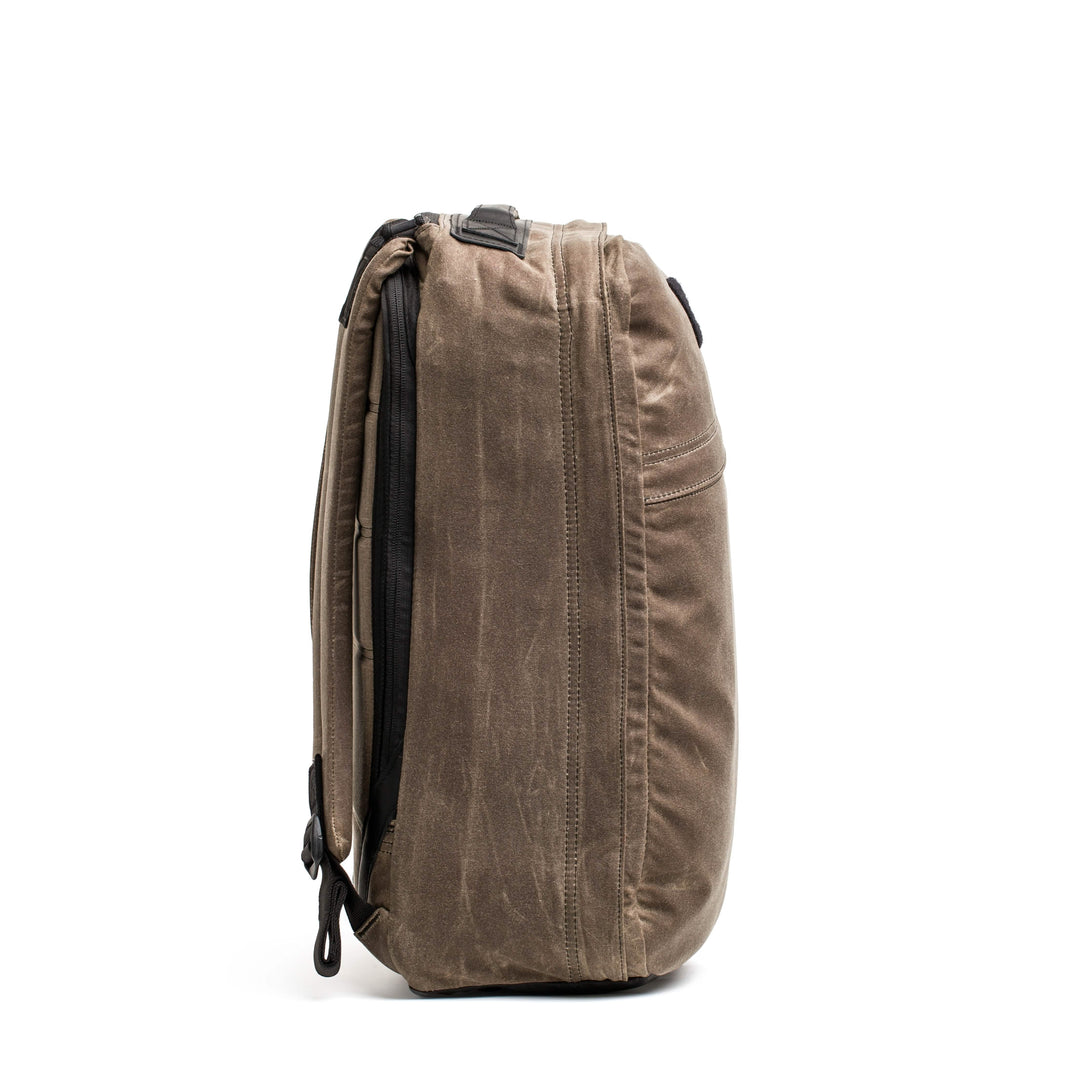 The GORUCK GR1 USA - Heritage is a brown retro canvas rucksack with a Martexin Wax finish, equipped with a side zipper and handle, shown standing upright against a white background.