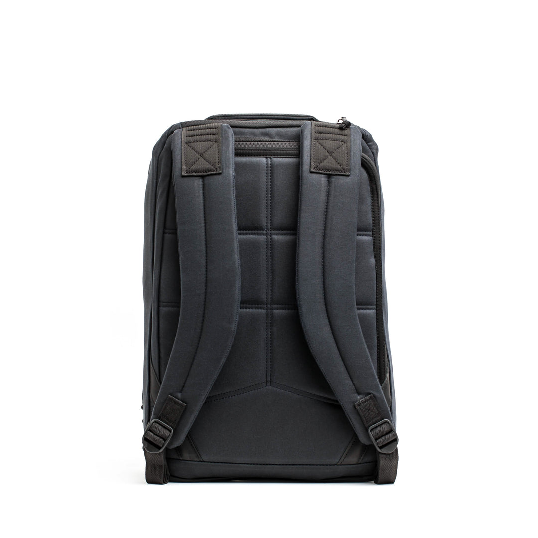The GR1 USA - Heritage by GORUCK is a retro rucksack featuring padded shoulder straps, a rectangular design, and durable waxed canvas construction, shown from the back.
