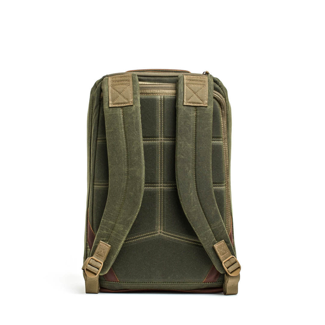 The GR1 USA - Heritage by GORUCK in green waxed duck canvas, with brown accents and padded straps, exudes rugged elegance from the back view, ideal for any adventure.