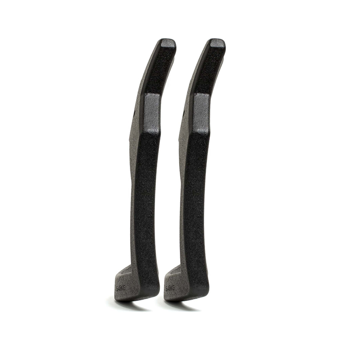 Two black Curved Ruck Plates from GORUCK EU stand upright, viewed from the side on a white background—ideal for stashing in your rucking weight vest for added resistance during workouts.