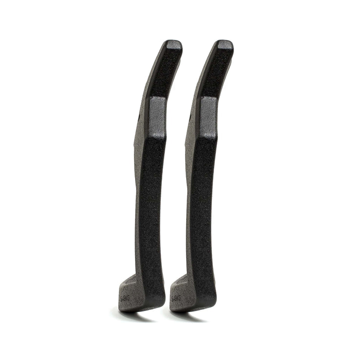 Two black Curved Ruck Plates from GORUCK EU stand upright, viewed from the side on a white background—ideal for stashing in your rucking weight vest for added resistance during workouts.